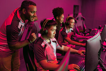 An enthusiastic esports team is strategizing intensely in a vibrant gaming environment for future competitions © Yaroslav Astakhov