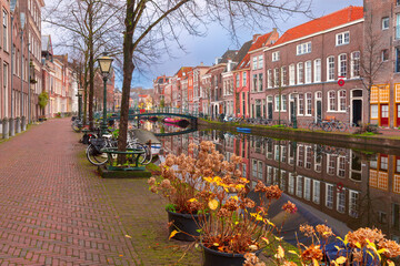 Historic canal with houses and bicycles in early morning in Leiden Netherlands