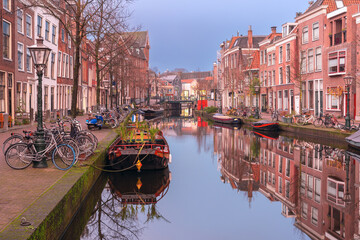 Historic canal with houses and bicycles in early morning in Leiden Netherlands