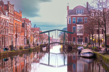 Historic canal with houses and bicycles in early morning in Leiden Netherlands