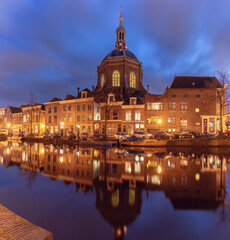 Marekerk church and canal with reflections at night in Leiden Netherlands