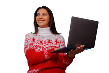 Woman using laptop wearing reindeer christmas sweater during holiday season, smiling and enjoying digital shopping