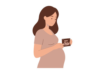 Pregnant woman holding ultrasound looking down smiling slightly in a neutral background