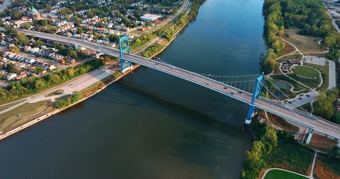 Flight above the Anthony Wayne Bridge over the Maumee River. Parks and residential areas of Toledo, Ohio, USA at waterfronts.