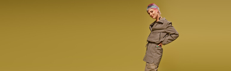 Young woman with colorful hair poses confidently in a vibrant studio setting