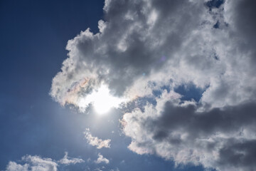Sunlight streams through clouds, creating a bright, ethereal effect in the sky.