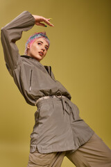 Creative fashion expression with a young woman showcasing colorful hair in the studio