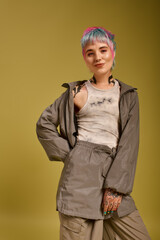 Young woman showcases colorful style in modern studio setting