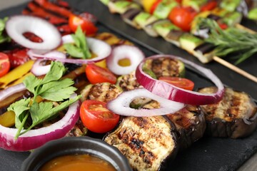 Vegetarian barbecue. Tasty grilled vegetables and sauce on table, closeup