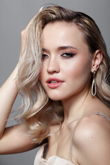 Beauty portrait of young blonde woman. Female with hairstyle with wet hair effect.