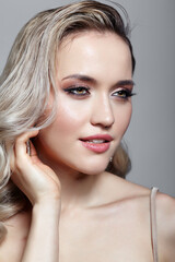 Beauty portrait of young blonde woman. Female with hairstyle with wet hair effect.