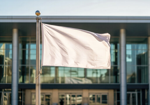 A blank rectangular flag mockup on a flagpole at the entrance of a convention center a corporate event or business summit presentation