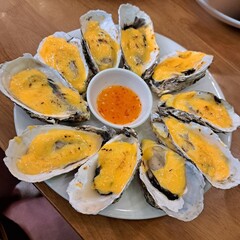 grilled oysters with cheese and hot pepper sauce, traditional asian food