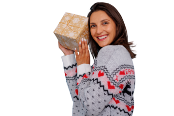 Woman holding christmas gift, smiling, celebrating holiday season, wearing festive winter sweater, transparent background