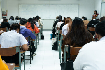 Students Writing Exam in Classroom Desks