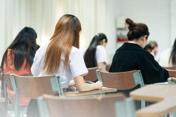 Students Writing Exam in Classroom Desks