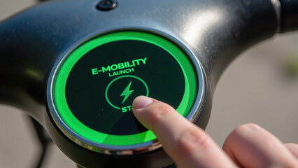 E mobility launch button with finger pressing start icon, showcasing modern technology and sustainable transport solutions