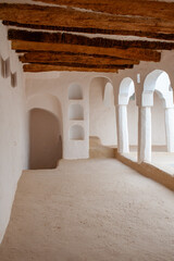 Interior of a traditional building with arches and wooden beams on the ceiling