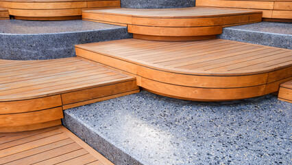 Wooden and marble seats decoration in modern curve geometric alternately and steps pattern design in viewpoint area at public park