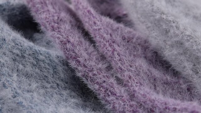 Close up of rotating mink and cashmere wool fabric showing fine fluffy fibers and detailed textile texture in macro view