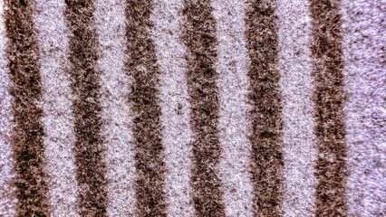 textured striped fabric closeup with soft brown and white fibers creating vertical lines for cozy wallpaper or modern banner background