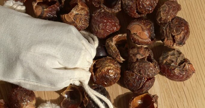 Soap nuts and eco laundry bag, close-up footage on a rotating table.