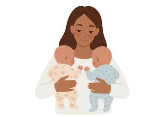 Woman holds two babies dressed in onesies one floral one dotted