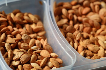 Plastic containers filled with nuts sitting on a table