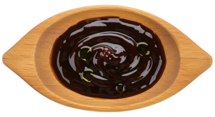 Dark brown barbecue sauce in wooden bowl isolated, sweet and savory condiment for grilling and dipping on no background