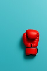 Red Boxing Glove on Blue: A vibrant red boxing glove, a symbol of strength and power, rests against a vivid blue backdrop, creating a striking visual contrast.