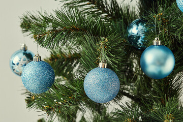 A Christmas tree decorated with a variety of blue ornaments.