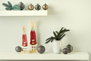 Modern Scandinavian-style Christmas decorations on white shelves.