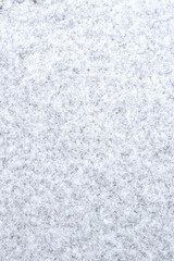 Obraz premium Abstract background view of the texture of the first snow covering the ground creating a winter pattern