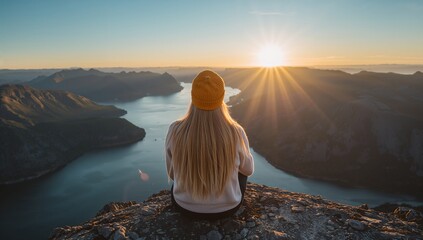 Woman Contemplating Sunrise Over Mountainous Landscape
