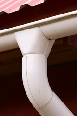 Fototapeta premium A white pipe sticking out of the side of a building, possibly for ventilation or drainage
