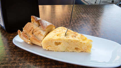 Delicious Spanish omelette served with crusty bread at an outdoor cafe during lunchtime