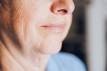 an elderly woman in a blue blouse