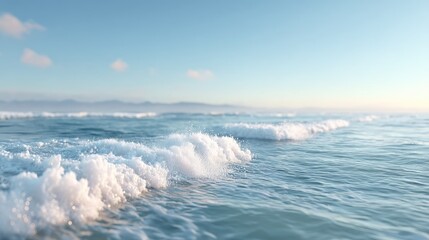 Fototapeta premium Dynamic Ocean Waves in Blue Waters with Whitecaps and Gentle Light Under Soft Sky