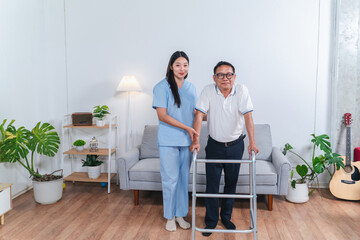 Supportive caregiver assists elderly man with mobility aid in bright indoor living space with plants and cozy atmosphere