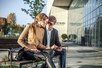 Business meeting of two partners and negotiations on work in the courtyard of business center