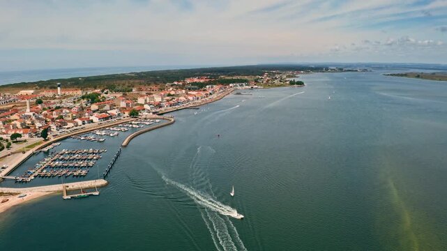 Aerial panoramic view of Torreira freguesia in Murtosa municipality Portugal coastal town port in Central Region Beira Litoral with Ria de Aveiro lagoon Atlantic ocean beach summer holiday destination