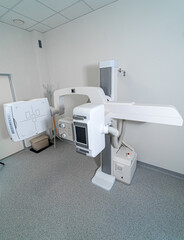 Modern radiology diagnostic equipment in clinic. Large x-ray imaging machine installed in clean hospital interior.