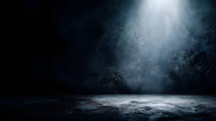 Dramatic spotlight illuminating a textured dark concrete room with atmospheric haze and shadows
