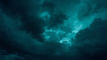 Dramatic turquoise sky filled with dark ominous clouds creating moody atmosphere