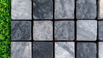 Gray and black stone paving tiles arranged in a grid pattern.