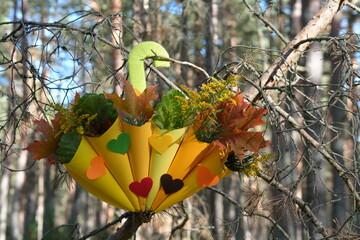 Creative Autumn Bouquet Shaped Like a Yellow Umbrella Hanging on a Forest Tree Branch