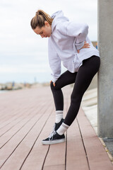 Fototapeta premium Exhausted woman resting after exercise
