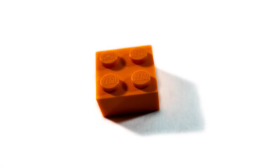 Obraz premium Miercurea Ciuc, Romania-29 September 2025: Single piece of orange Lego bulding brick on white background.