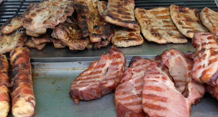 grilling meat on a grill, fast and fat food theme
