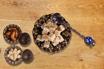 Ramadan concept, sugar in muslim bronze plate